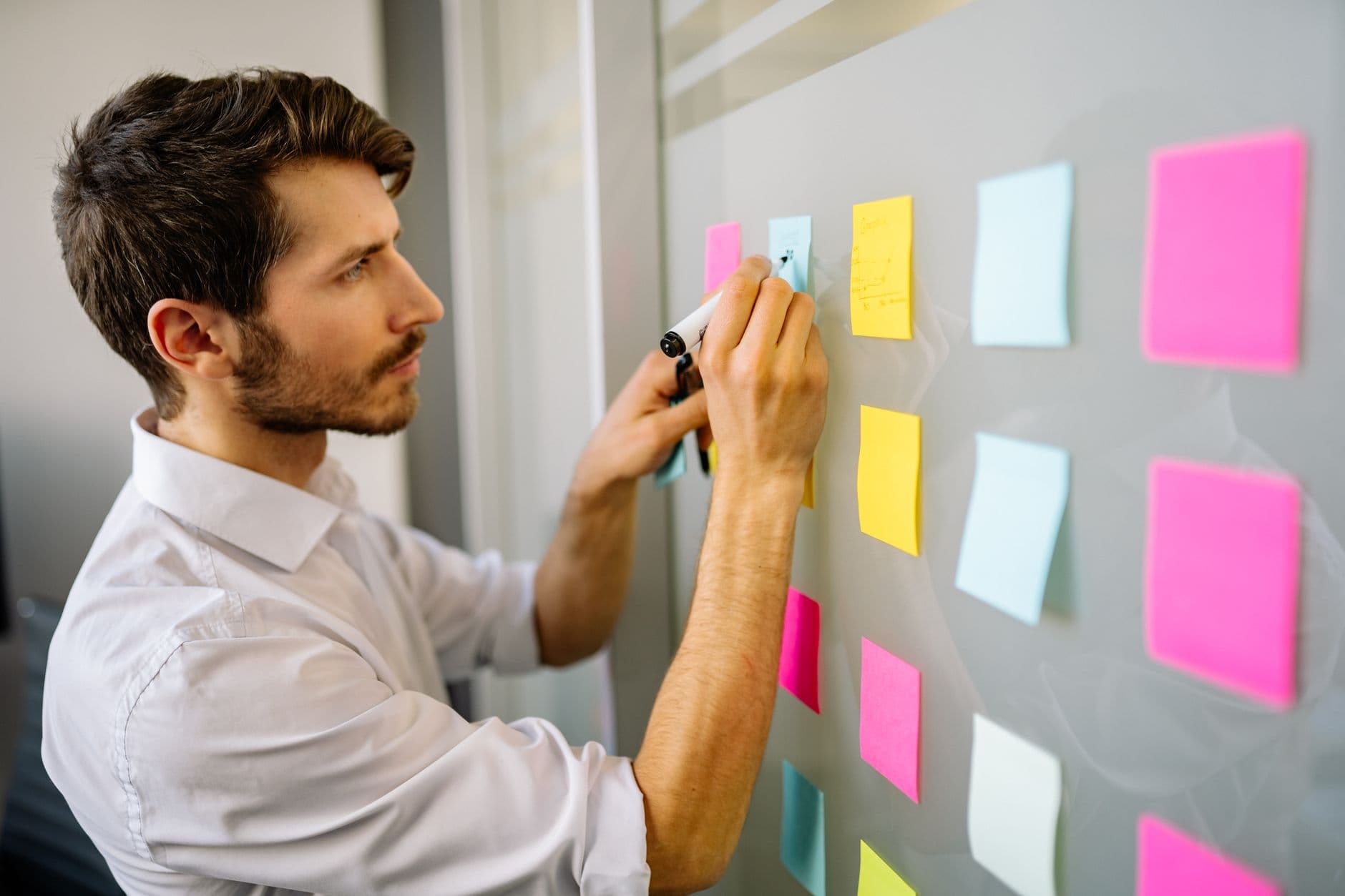 Tableau d'hypothèses produit sur une table avec post-its et carnet